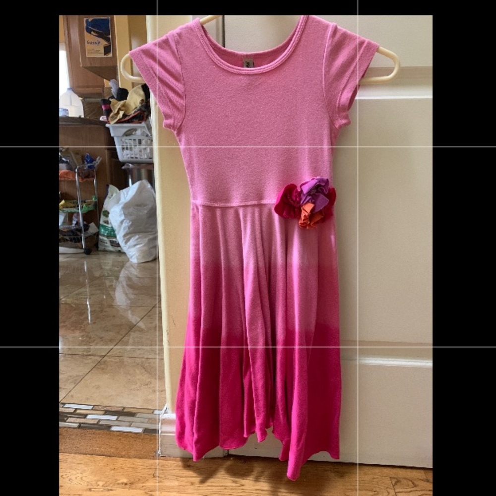 A pink dress with a flower by the waist